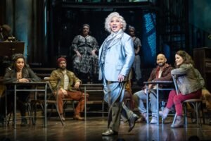 Melanie La Barrie as Hermes and company. (Photo: Marc Brenner)